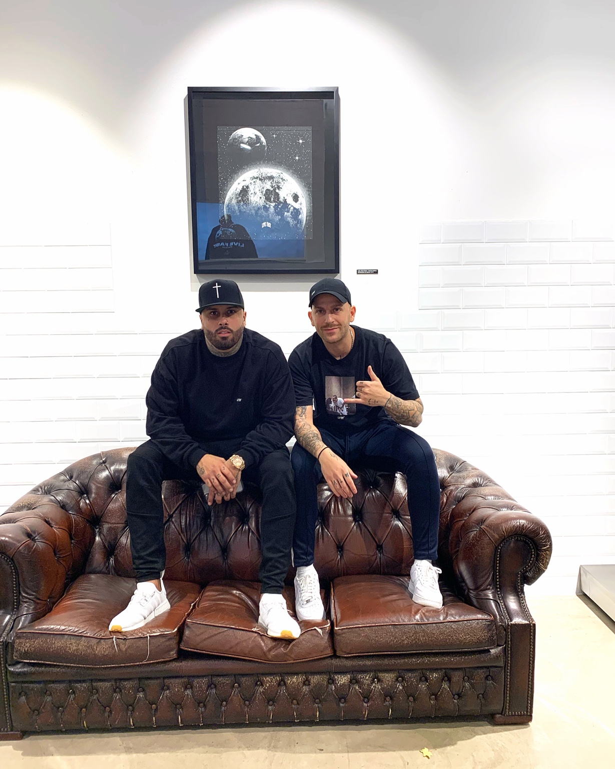 DJ AND-J and an artist seated backstage