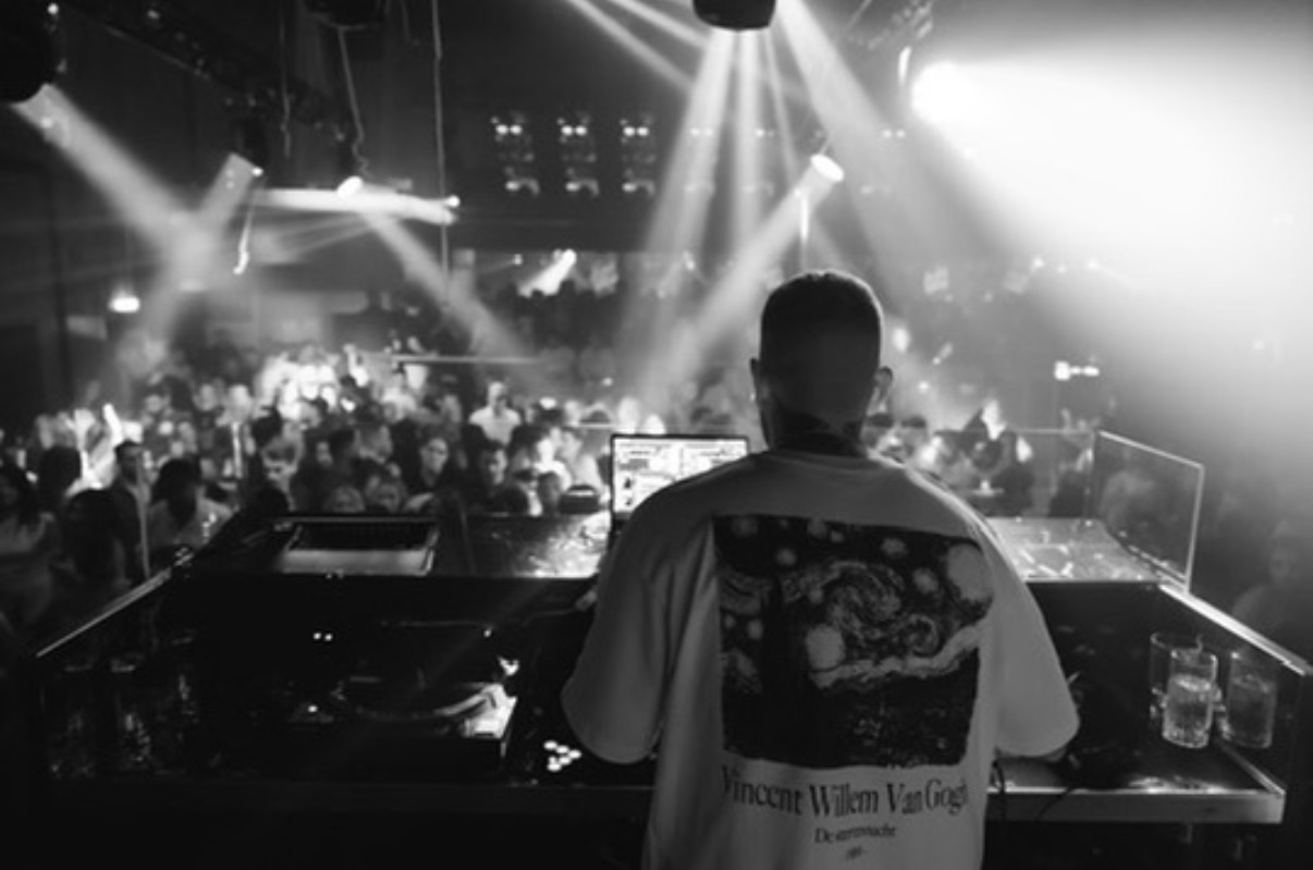 DJ AND-J performing for a club crowd